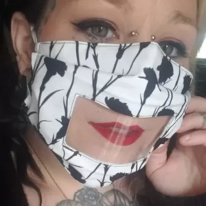 Black and white floral anti fog face mask with clear vinyl window. shown on female model