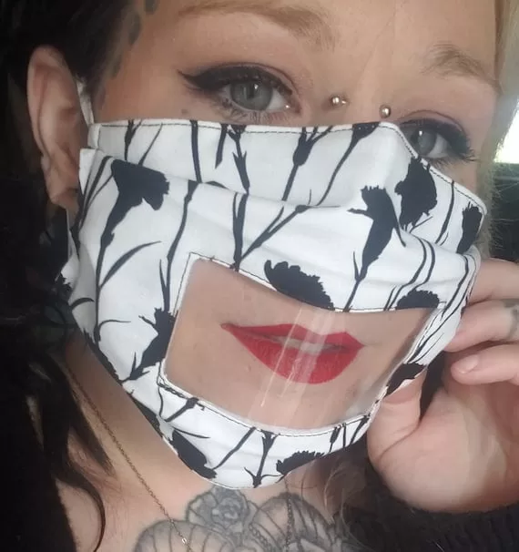 Black and white floral anti fog face mask with clear vinyl window. shown on female model