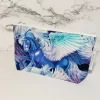 Flying horse mystical creature theme with metallic fabric accents. Structured box bottom accessory bag. Lined with white fabric and matching zipper. Convenient zipper pull. 100% Cotton fabric. Measures 8.5 inches wide, 5 inches tall.
