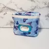 Small blue butterfly pattern accessory bag with front window pocket for makeup remover wipes. Fully lined interior. Zip closure with attached keyring. Measures 6 inches wide. Window pocket allows easy access to a packet of wipes (not included).
