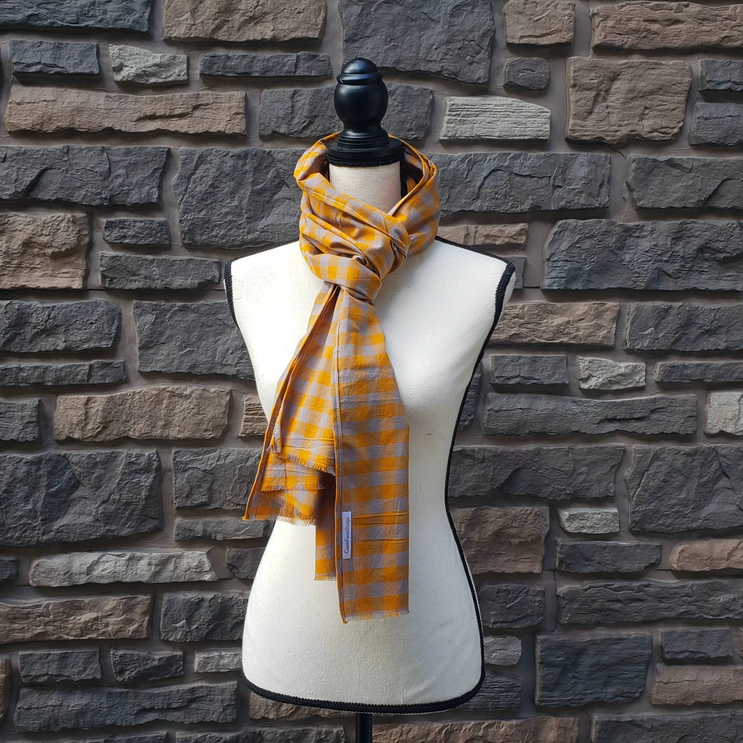 Lightweight fall or spring scarf. orange and gray plaid pattern with fringed ends. 72 inches long.