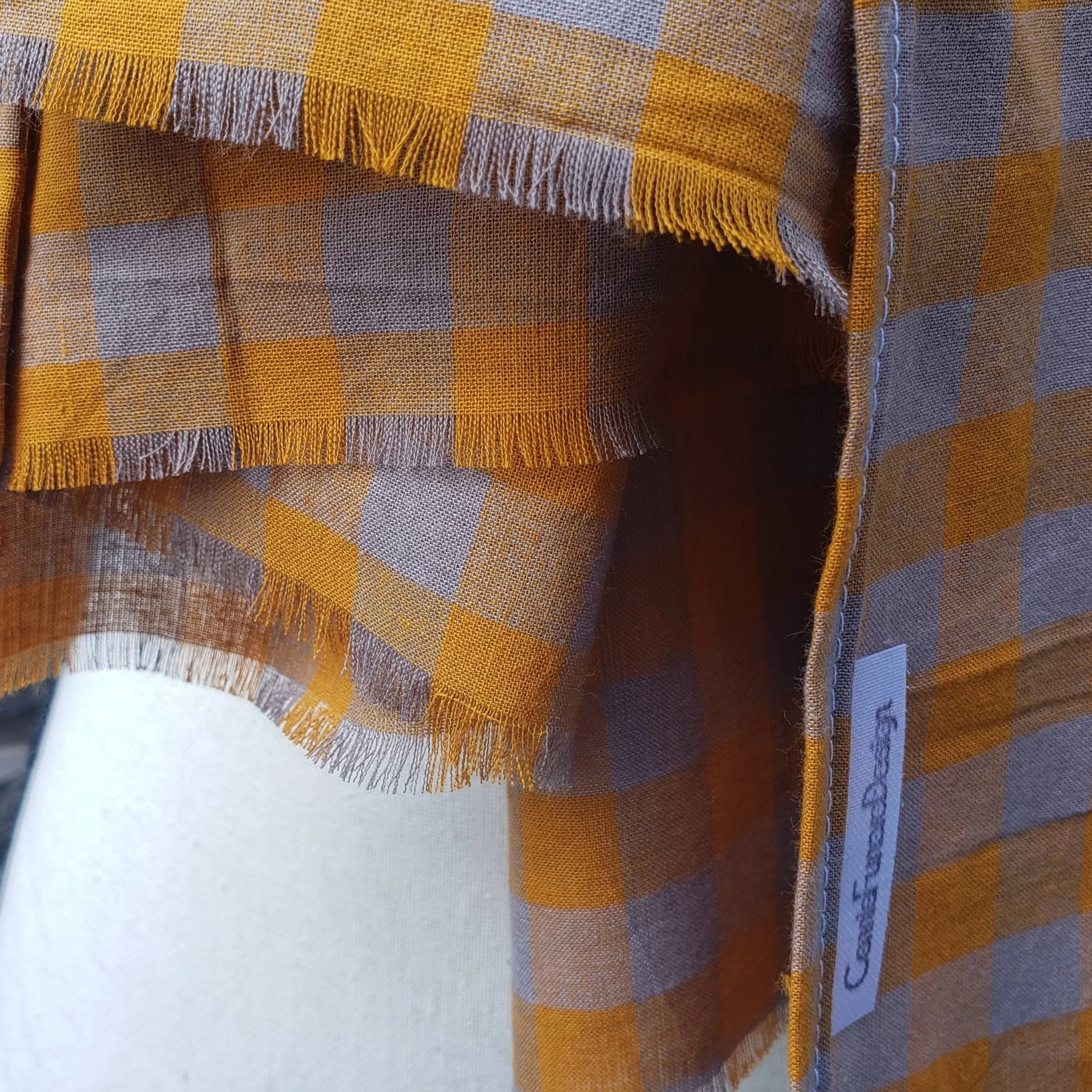 Lightweight fall or spring scarf. orange and gray plaid pattern with fringed ends. 72 inches long.