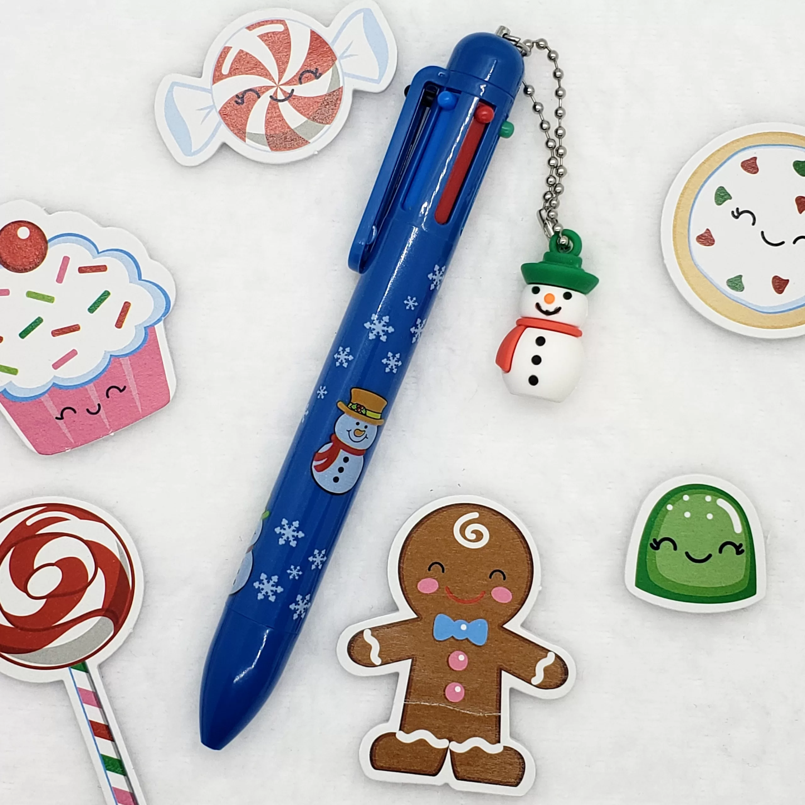 6-in-1 Multi-Color Snowman Ballpoint Pen with mini snowman charm, featuring six vibrant ink colors and a festive design.