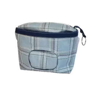 6 inch blue plaid makeup bag with front window pocket to hold and dispense makeup wipes. Coordinating zipper and navy blue liner, plus a keychain ring tab.