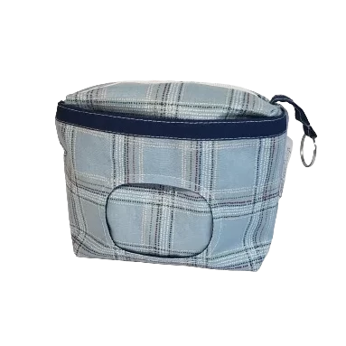 6 inch blue plaid makeup bag with front window pocket to hold and dispense makeup wipes. Coordinating zipper and navy blue liner, plus a keychain ring tab.