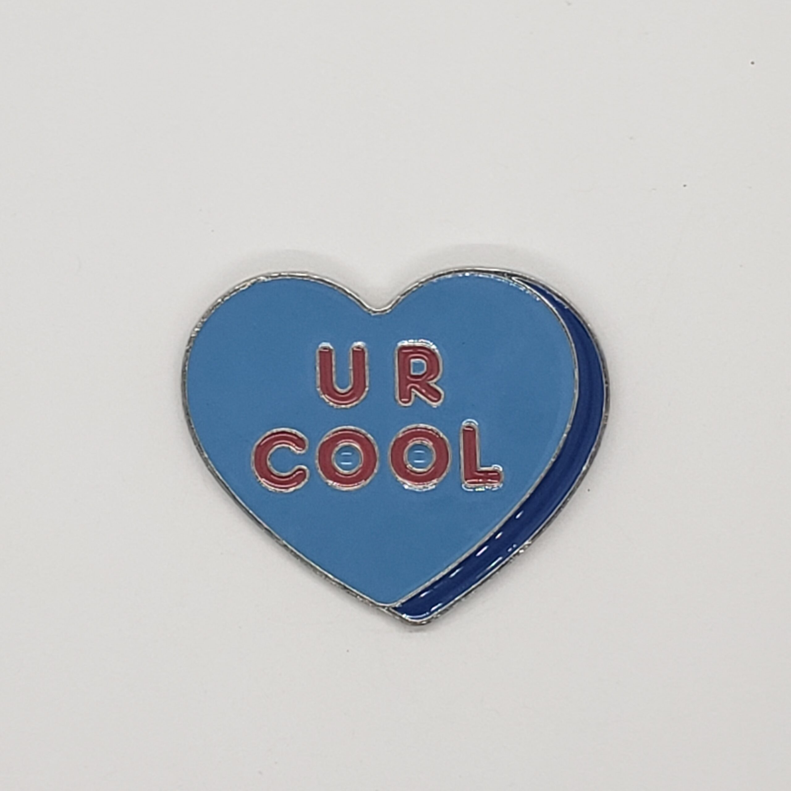 large blue retro enamel heart shaped pin. The phrase "U R COOL" in bold text.