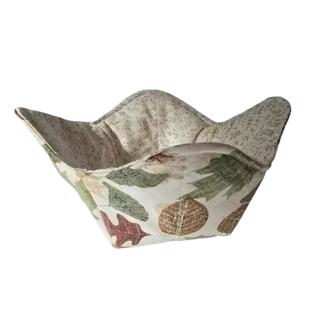 Autumn Leaves Bowl Cozy, 10-inch reversible kitchen accessory made from 100% cotton, ideal for microwave use and featuring a vibrant autumn leaves design on one side and a complementary neutral floral pattern on the other.