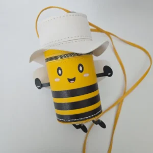 Handmade bumble bee character purse in vegan leather with white wings, matching hat, cute face, crossbody strap, and secure zip closure.