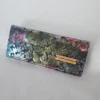 Handmade vegan leather wallet with a metallic floral pattern, silver-tone hardware, multiple pockets, and card slots.