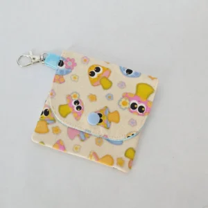 Handmade Kawaii Cute Mushroom Wallet with three pockets, a snap closure, and a lobster claw clasp. Made from cream-colored fabric with cute cartoon mushrooms and a blue sky lining with small butterflies.